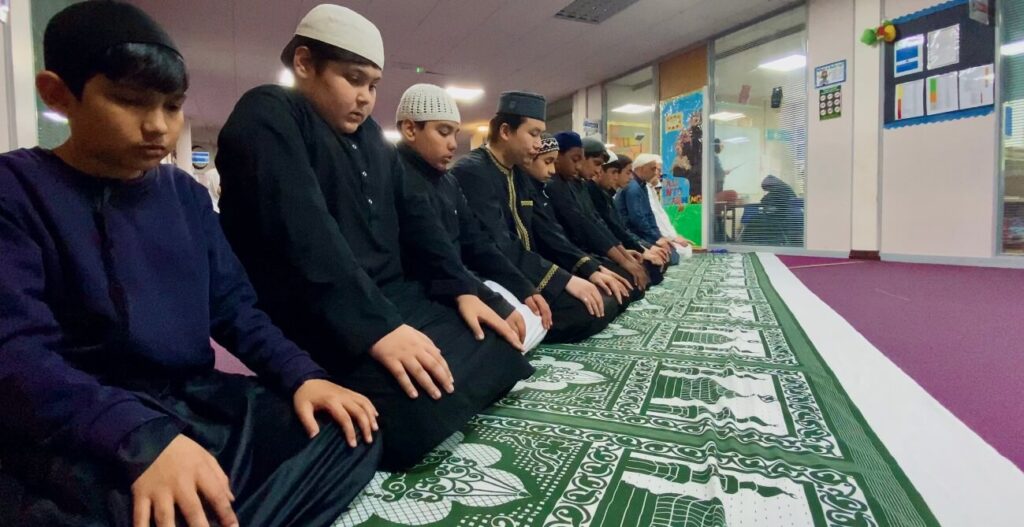 boys seated in prayer 